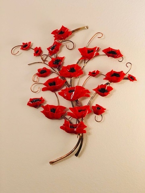 Poppy Bouquet: red fused-glass poppies clustered on a copper-stem armature, by Annie Dotzauer and Rhonda Waters.