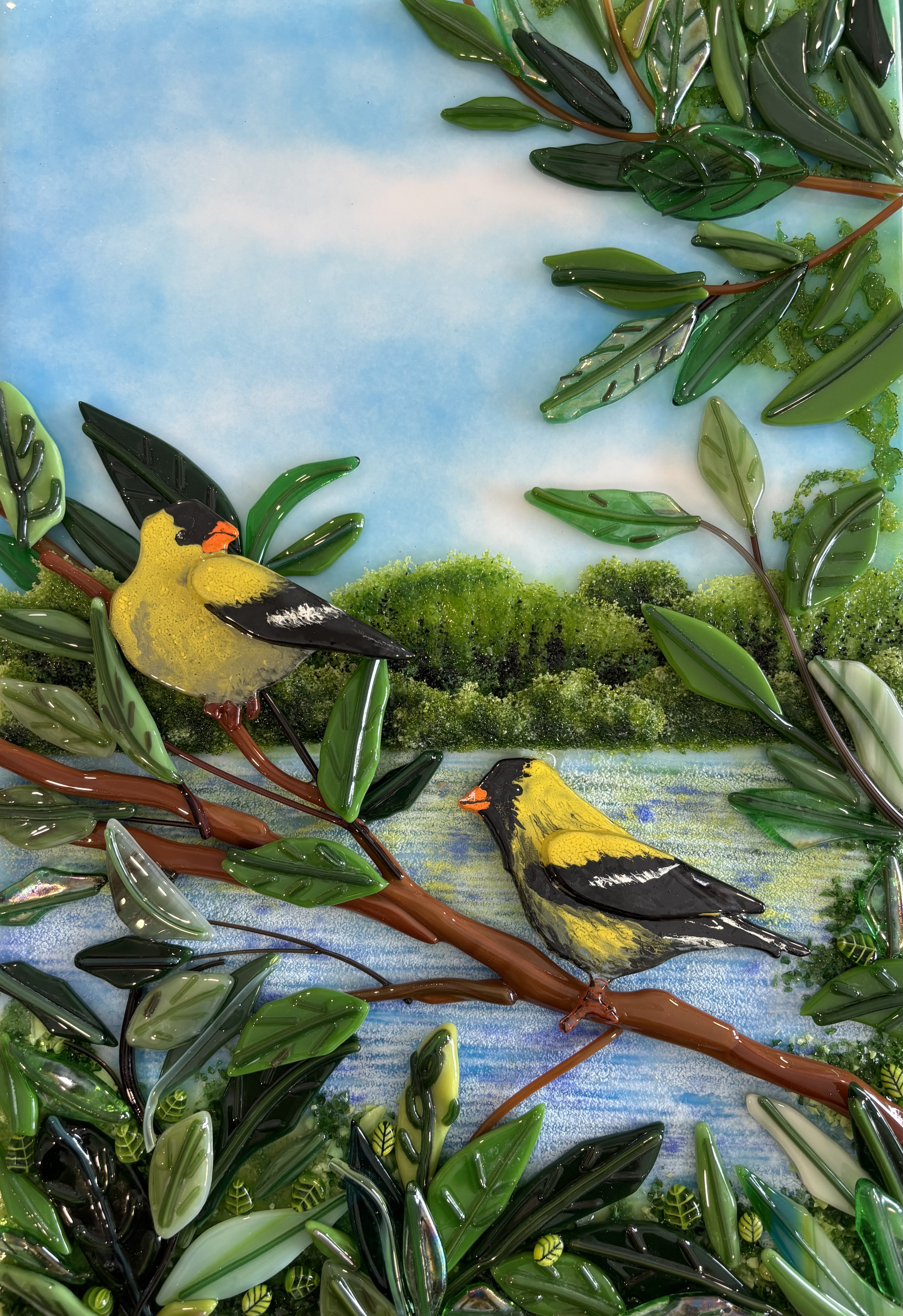 Lead image of the Forest room: goldfinches on green branches in fused glass.